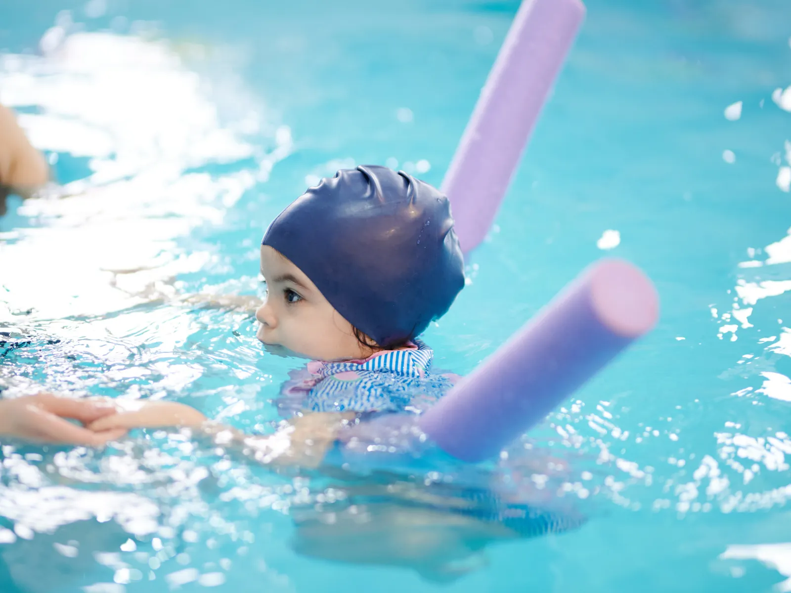 Coach giving a one-on-one swim lesson