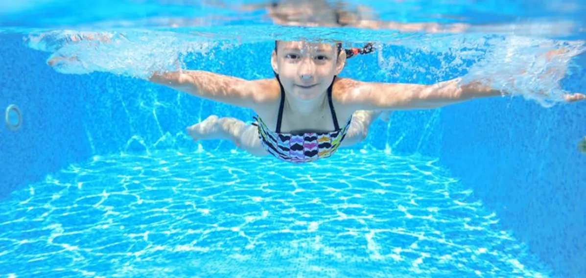 Young swimmer learning in a warm pool at Hippo in the Bathtub